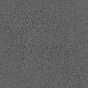 Close-up of a rough gray concrete surface with a granular texture.